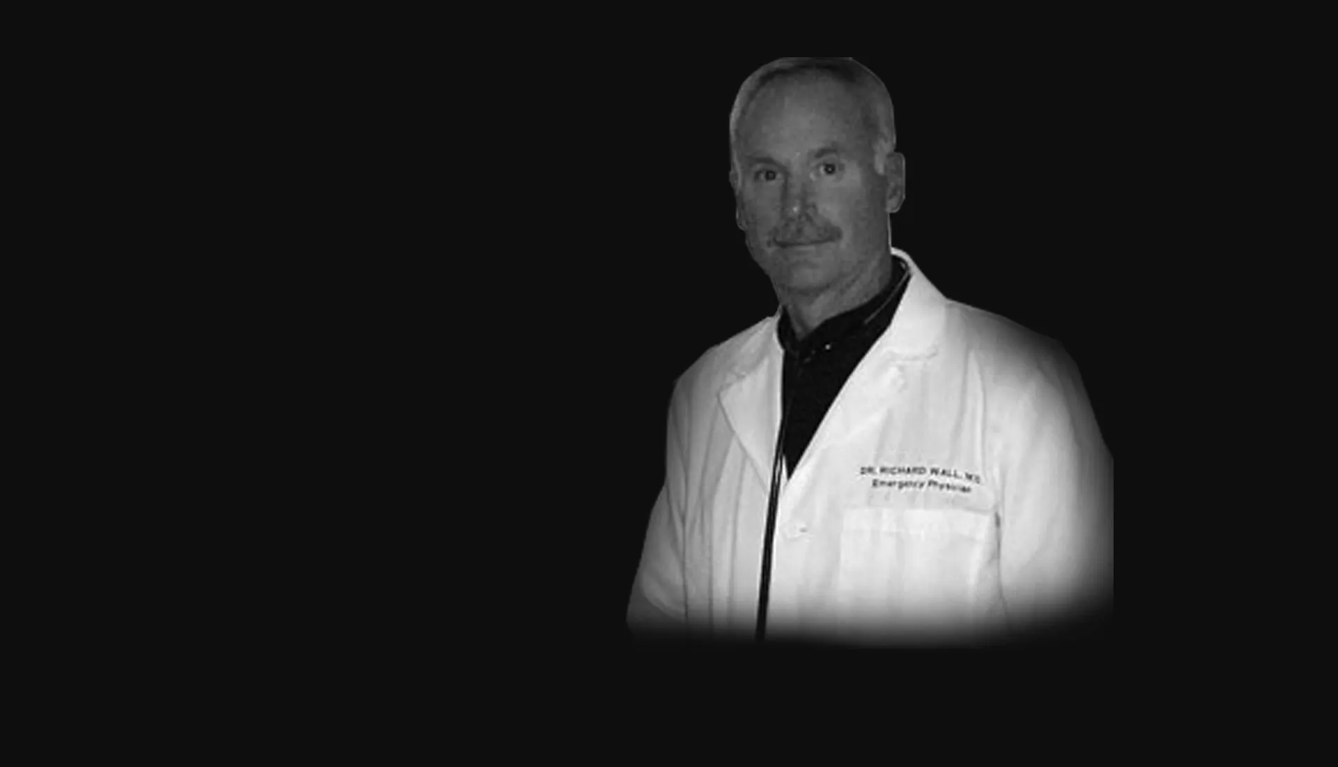 Dr. Richard Wall in his white coat as an emergency physician